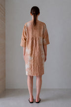 Foro dress in an earth tone, back view with a gathered back