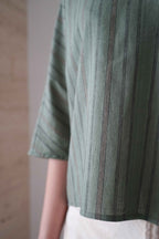 Detail of the green striped fabric, sleeve and hem of the Marei blouse