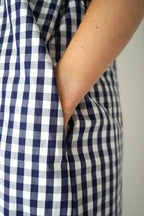 Detail of the side pocket and blue gingham fabric of the Amance dress