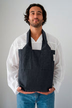 Areal tote bag in anthracite, held in front of the body