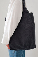 Areal tote bag in anthracite, side view worn over the shoulder